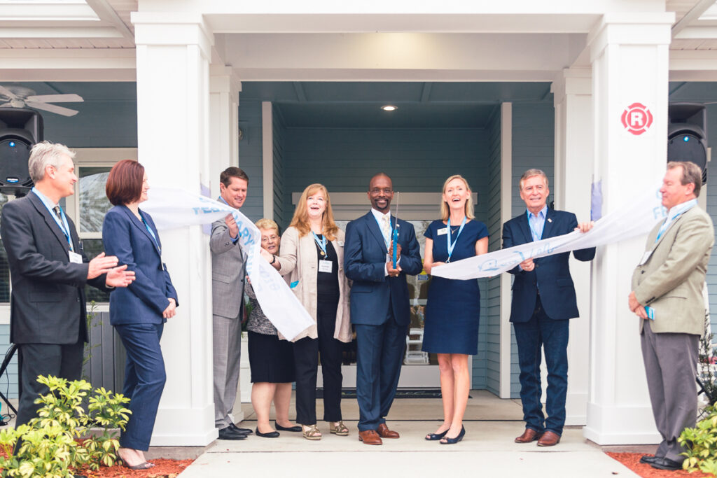 Officials celebrate a ribbon-cutting ceremony at a grand opening event in orlando.